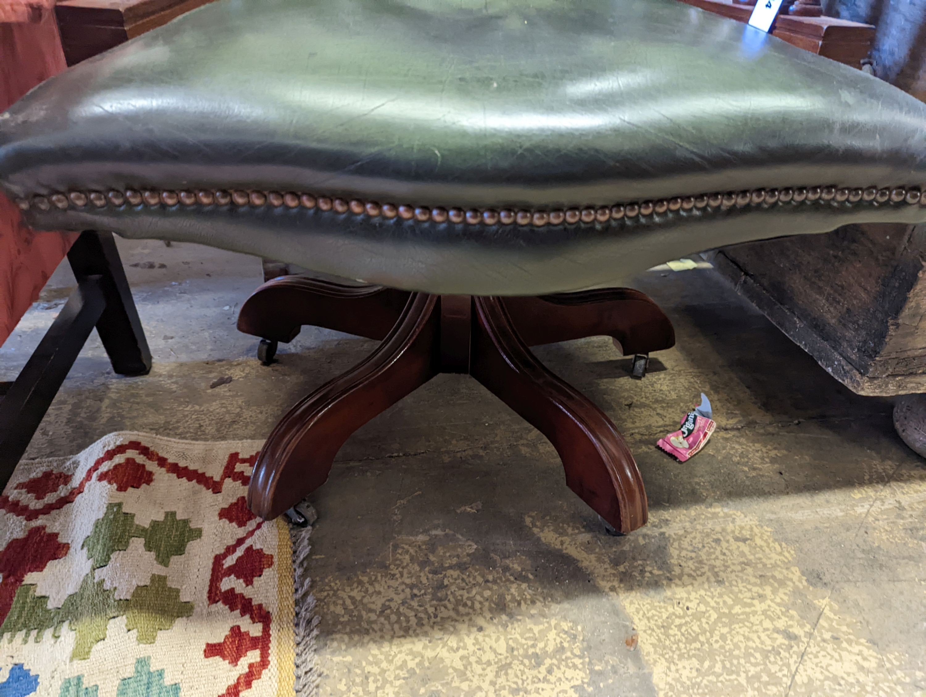 A green leather upholstered desk chair, width 60cm, depth 56cm, height 110cm